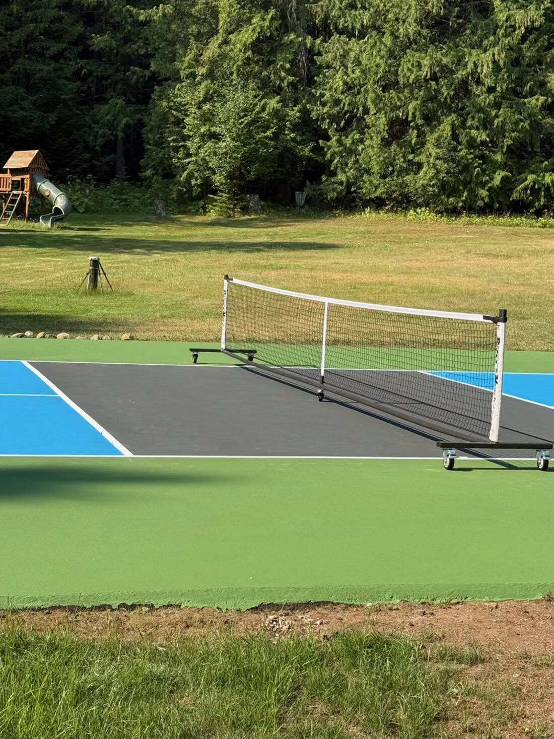 Painted pickleball kitchen and baseline showing textured acrylic court surface