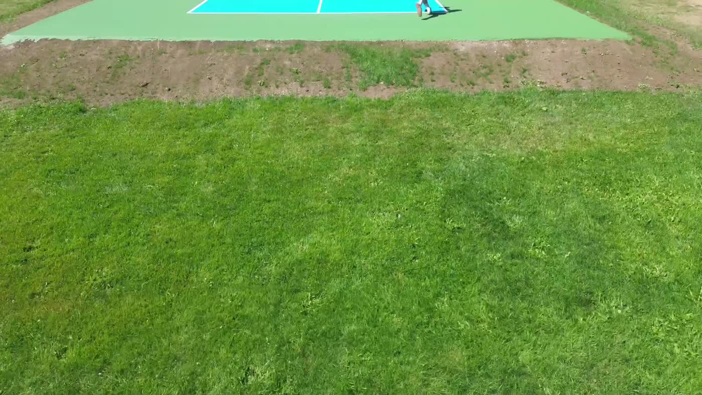 Freshly painted blue and green pickleball court with white lines in the Okanagan, British Columbia